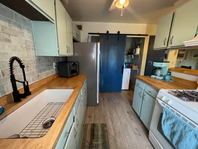 a kitchen with stainless steel appliances granite countertop a refrigerator sink and cabinets