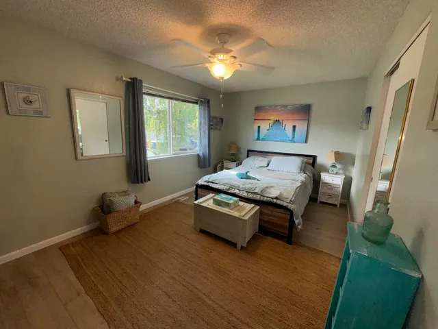 a spacious bedroom with a bed and a chandelier