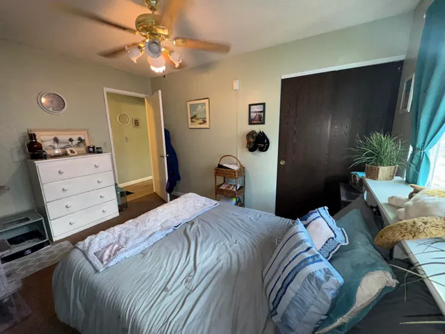 a bedroom with a bed and a mirror