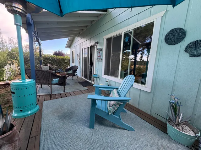 a view of a wooden deck and a yard