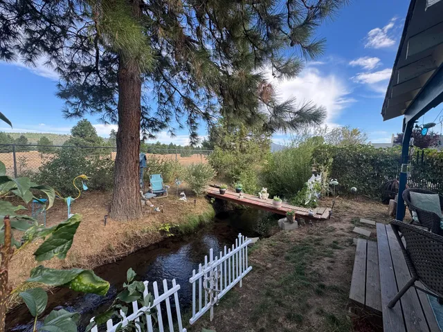 an outdoor living area with furniture and a garden