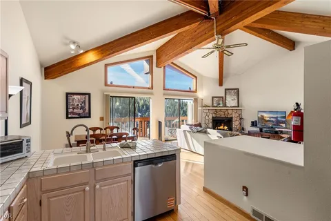a kitchen with sink a stove and cabinets