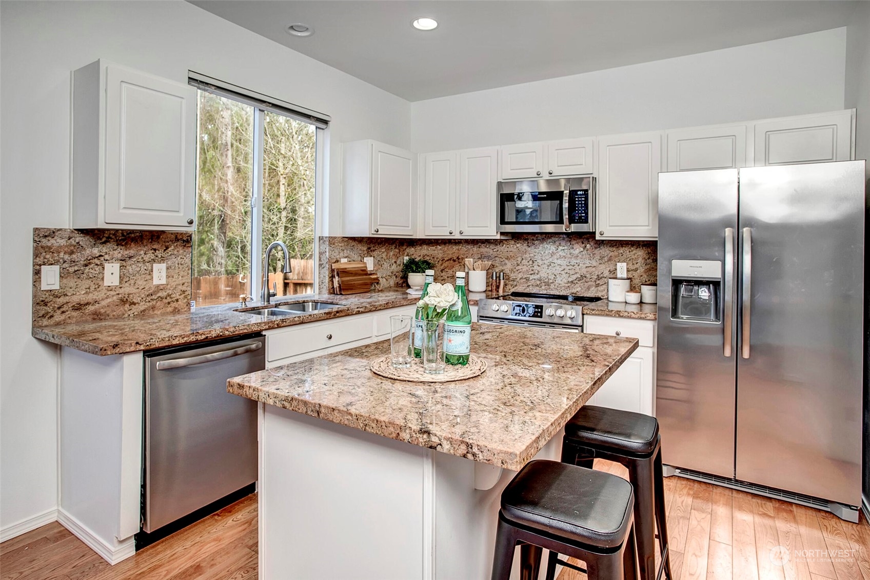 453 Field Place Northeast Renton, WA 98059 - Photo 11 of 36 a kitchen with stainless steel appliances granite countertop a sink a stove a refrigerator and a refrigerator