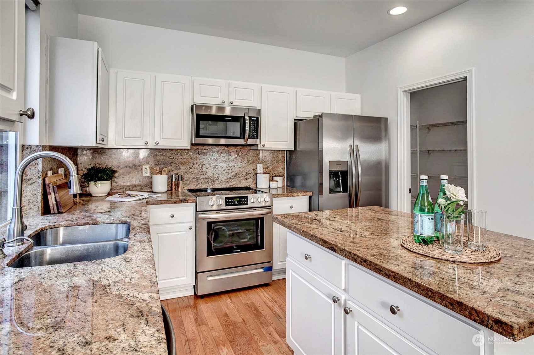 453 Field Place Northeast Renton, WA 98059 - Photo 12 of 36 a kitchen with granite countertop a sink stove and refrigerator