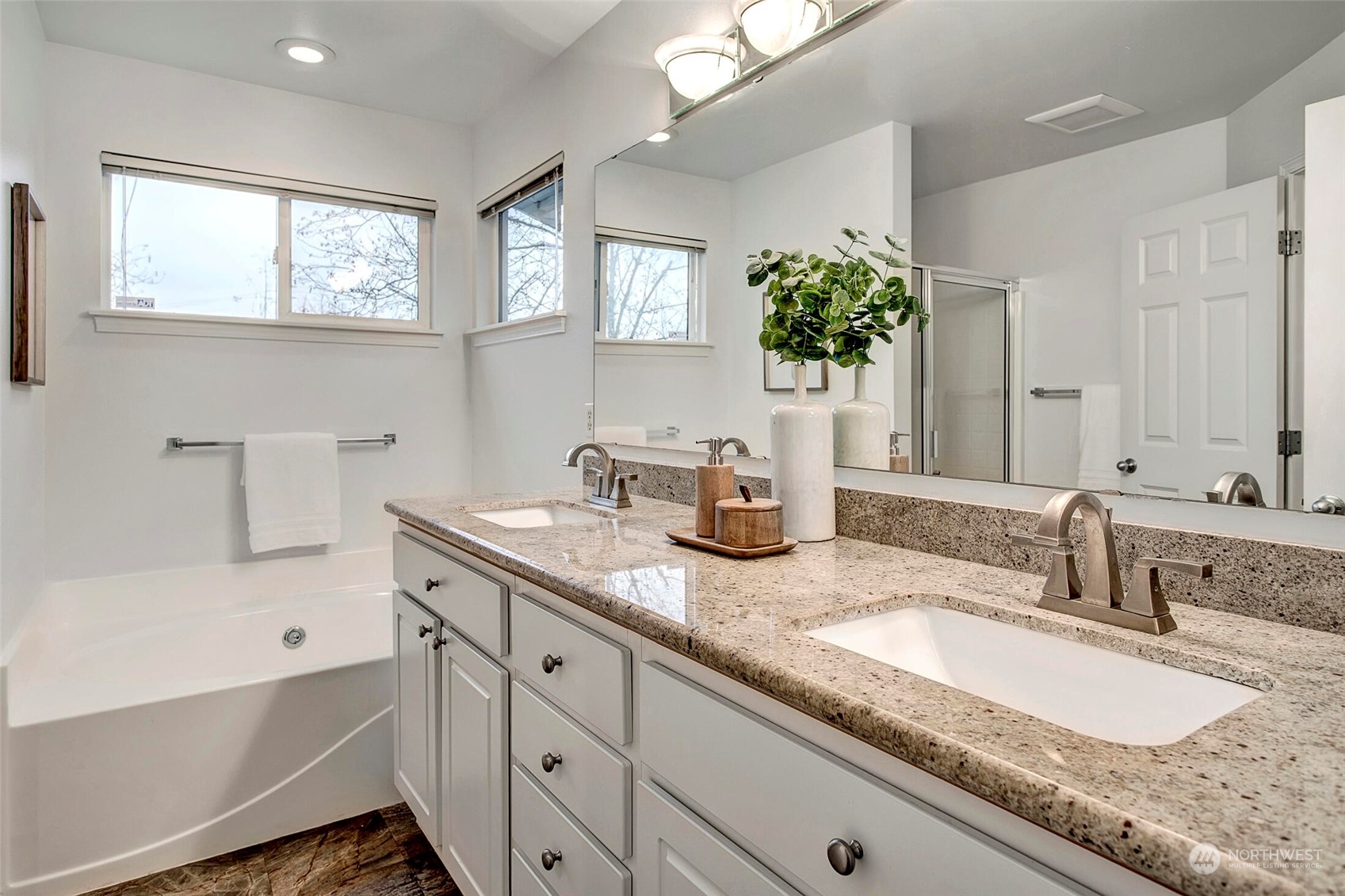 453 Field Place Northeast Renton, WA 98059 - Photo 18 of 36 a bathroom with double vanity sinks a mirror and a bathtub