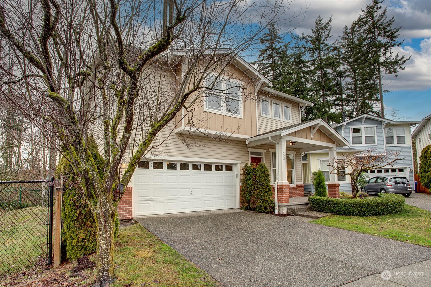 453 Field Place Northeast Renton, WA 98059 - Photo 22 of 36 a front view of a house with a yard and garage