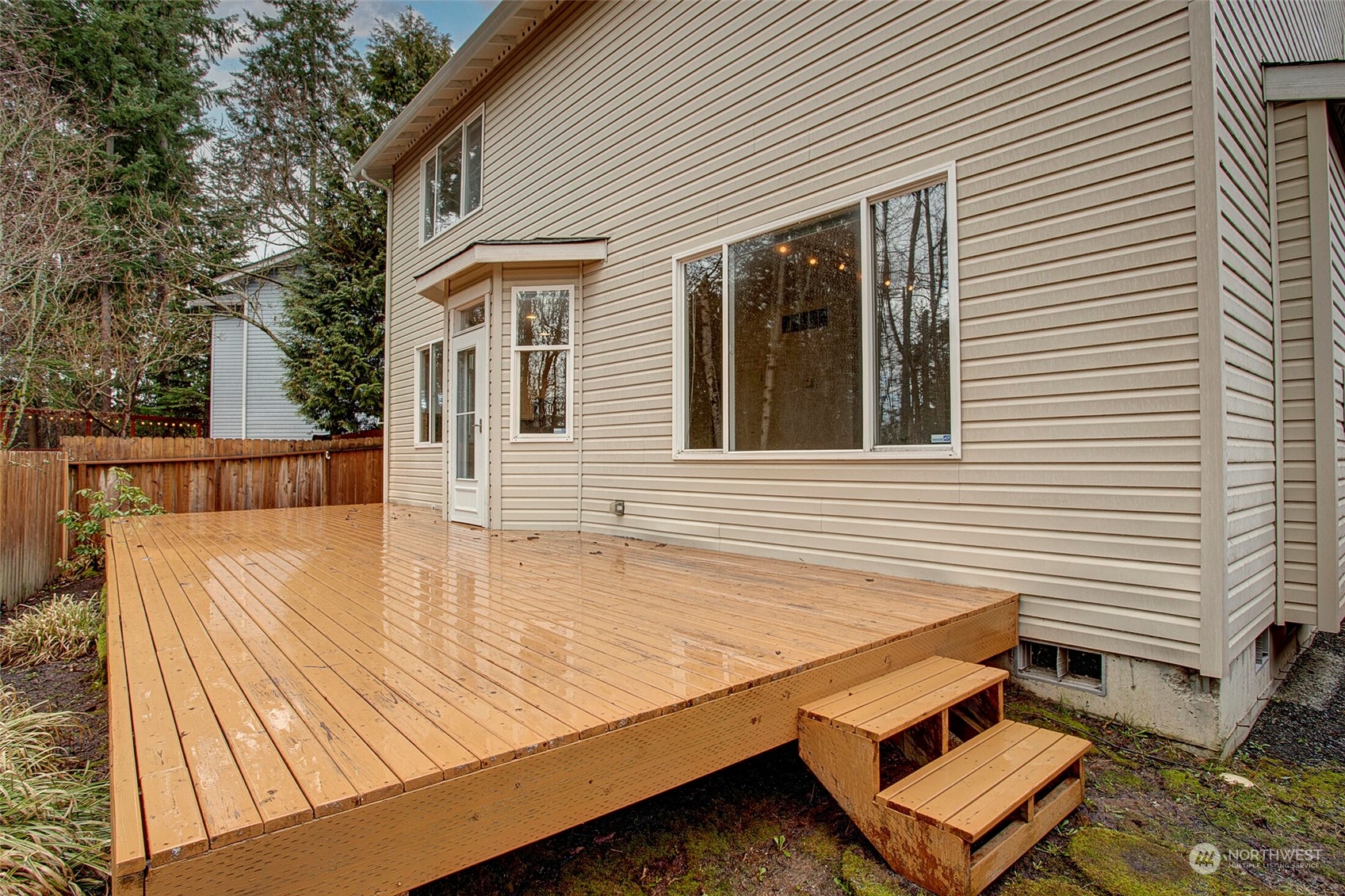 453 Field Place Northeast Renton, WA 98059 - Photo 29 of 36 a view of a patio with table and chairs with wooden floor and fence and a barbeque grill