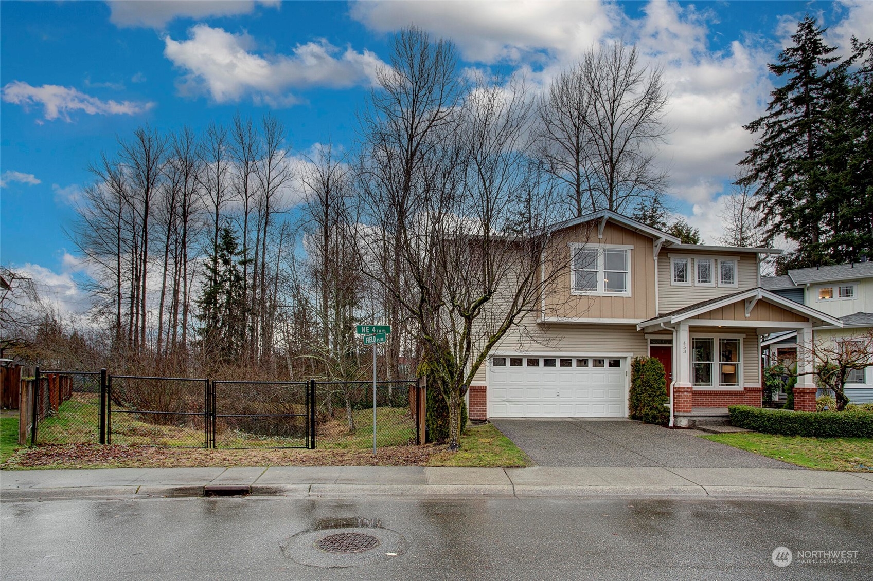 453 Field Place Northeast Renton, WA 98059 - Photo 30 of 36 a view of a white house with a large tree and a yard