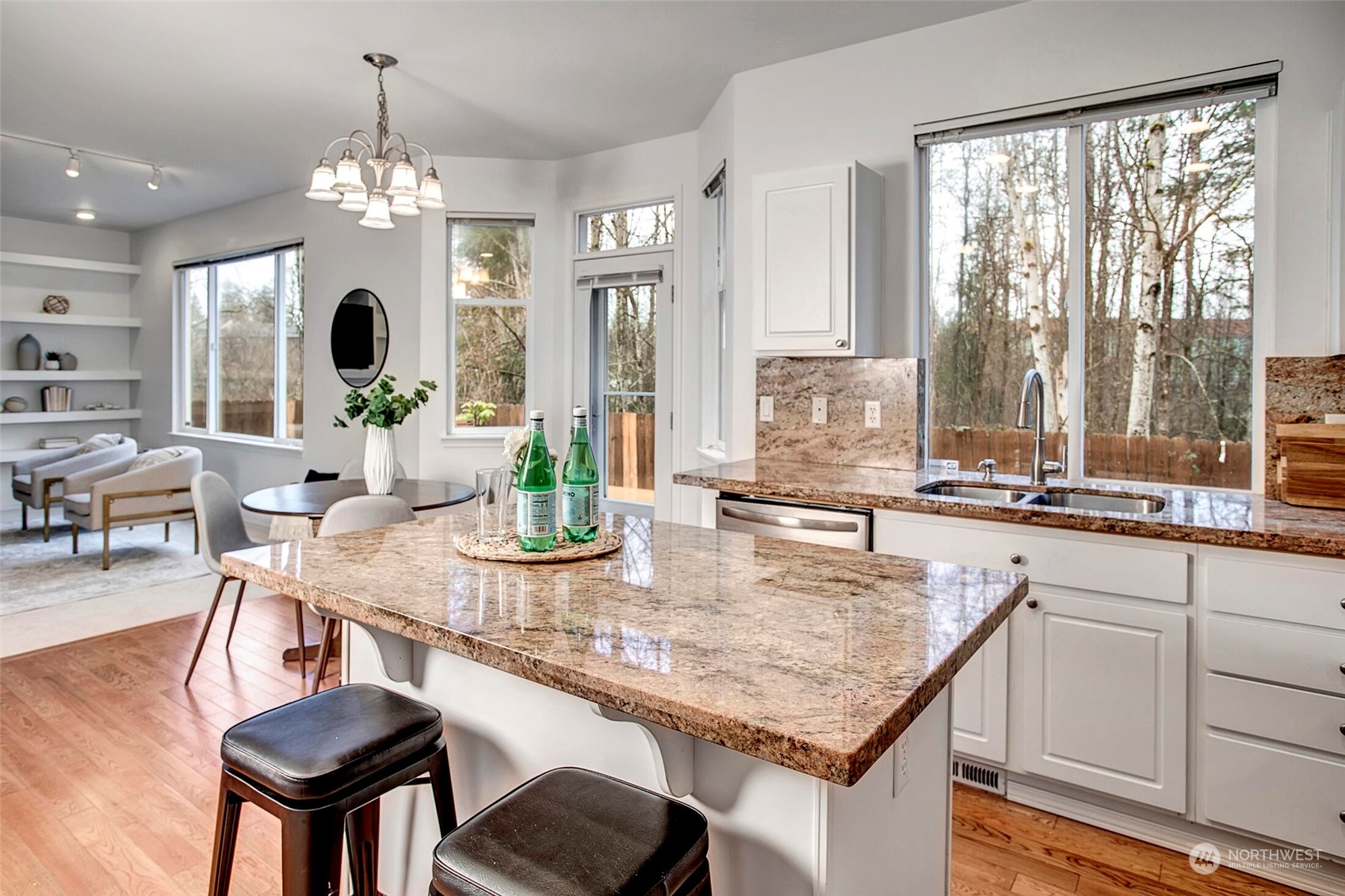 453 Field Place Northeast Renton, WA 98059 - Photo 5 of 36 a kitchen with a table chairs and chandelier