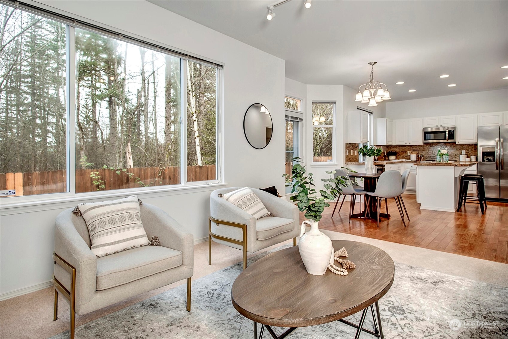 453 Field Place Northeast Renton, WA 98059 - Photo 8 of 36 a living room with furniture potted plant and a large window