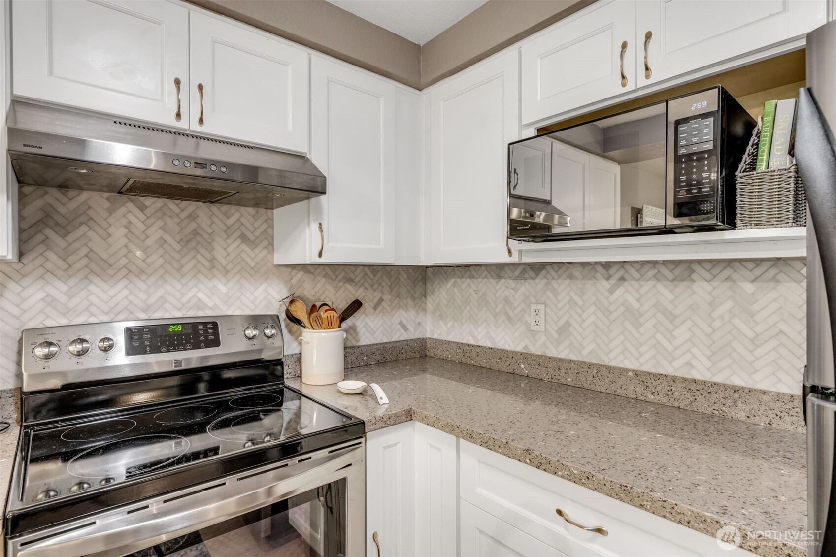 4231 Northeast 5th Street, Unit E101 Renton, WA 98059 - Photo 12 of 29 a kitchen with a stove and a microwave