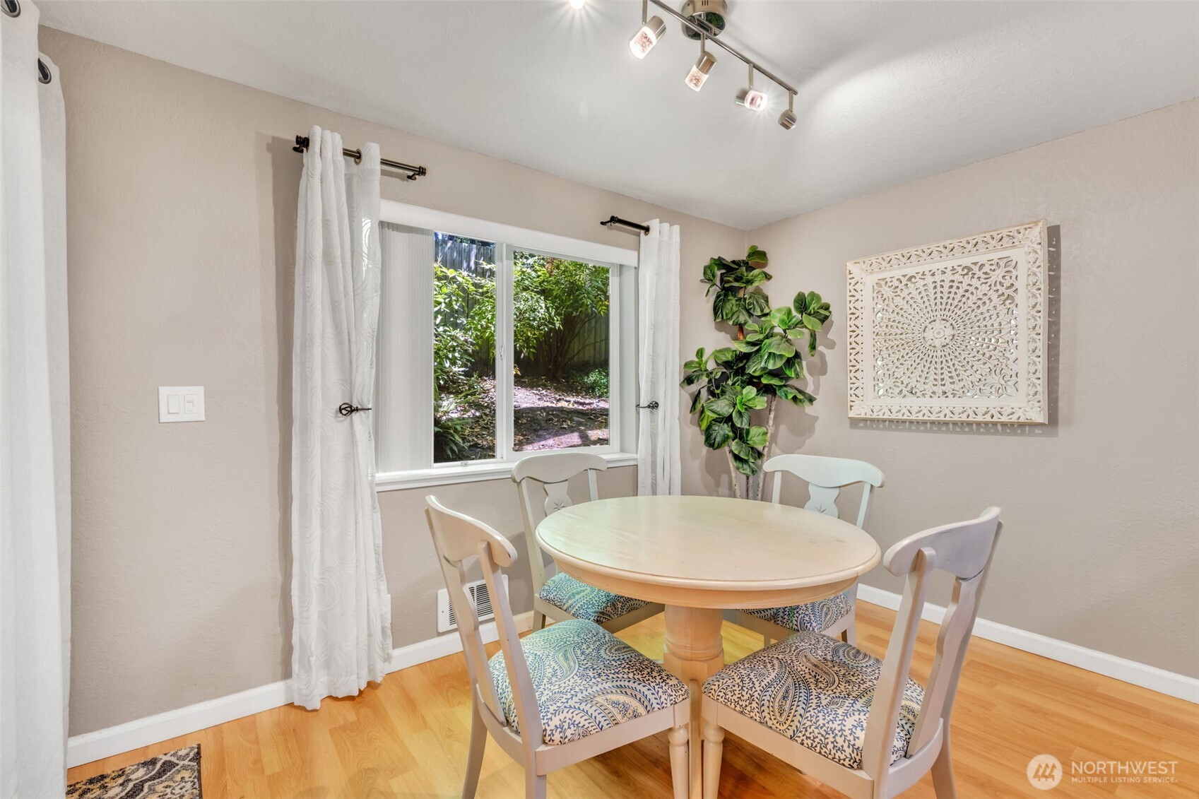 4231 Northeast 5th Street, Unit E101 Renton, WA 98059 - Photo 16 of 29 a view of a dining room with furniture and a potted plant