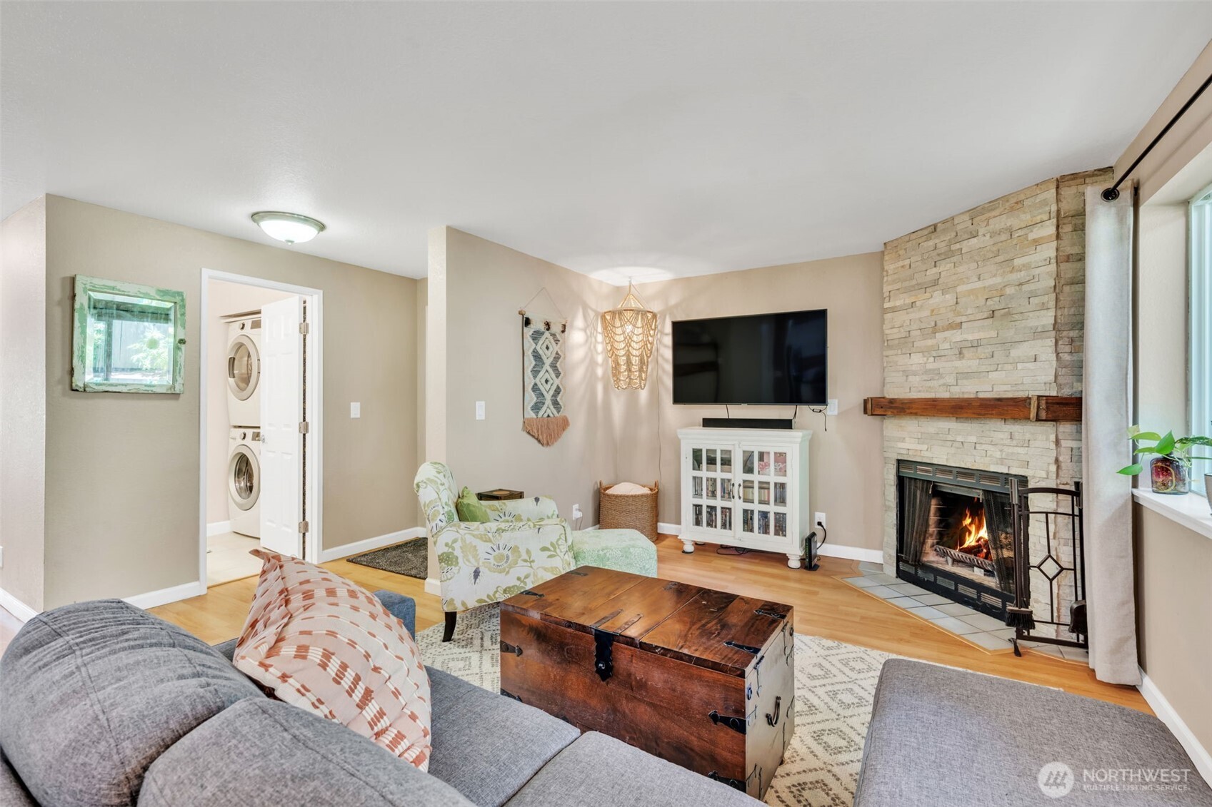 4231 Northeast 5th Street, Unit E101 Renton, WA 98059 - Photo 5 of 29 a living room with furniture a flat screen tv and a fireplace