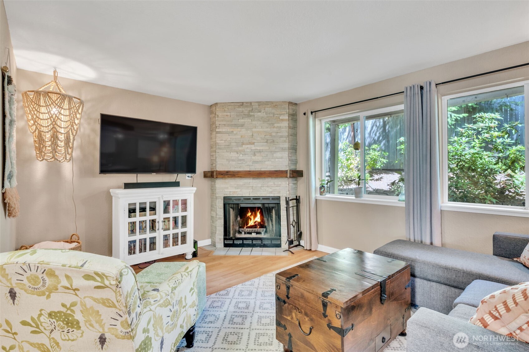 4231 Northeast 5th Street, Unit E101 Renton, WA 98059 - Photo 7 of 29 a living room with fireplace furniture and a flat screen tv