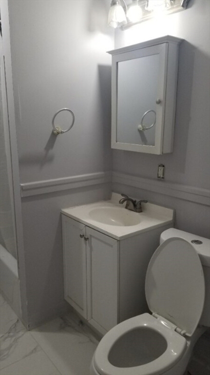 191 Eastern Avenue, Unit 2 Worcester, MA 01605 - Photo 6 of 6 a bathroom with a toilet sink and mirror