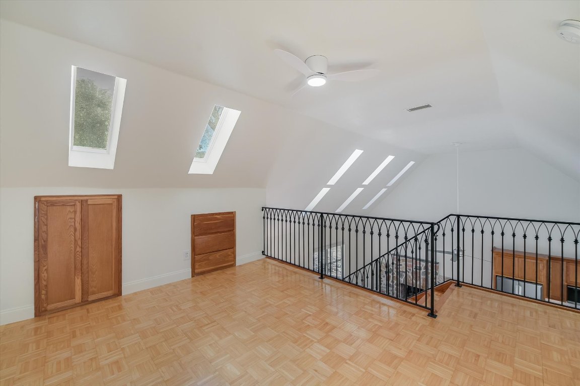 302 Lago Verde Road Lakeway, TX 78734 - Photo 11 of 21 Bonus room featuring a ceiling fan, vaulted ceiling, and a skylight