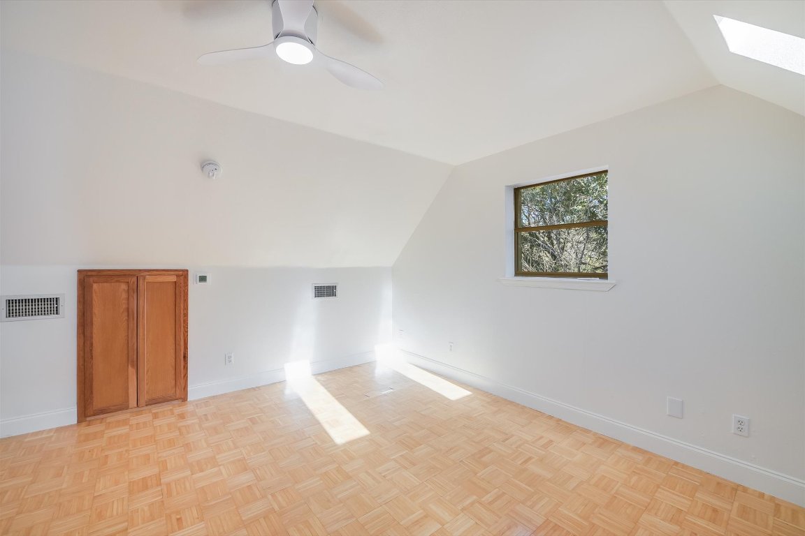 302 Lago Verde Road Lakeway, TX 78734 - Photo 12 of 21 Additional living space with vaulted ceiling and a skylight