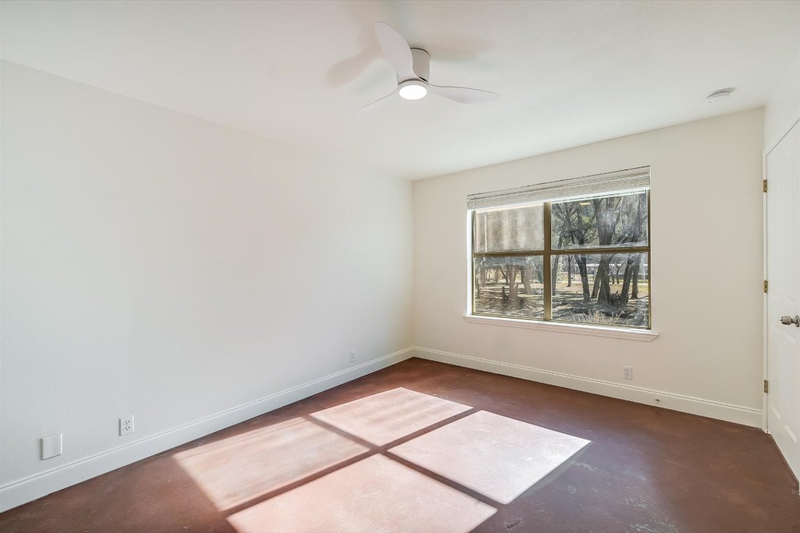 302 Lago Verde Road Lakeway, TX 78734 - Photo 13 of 21 Empty room featuring finished concrete flooring and ceiling fan