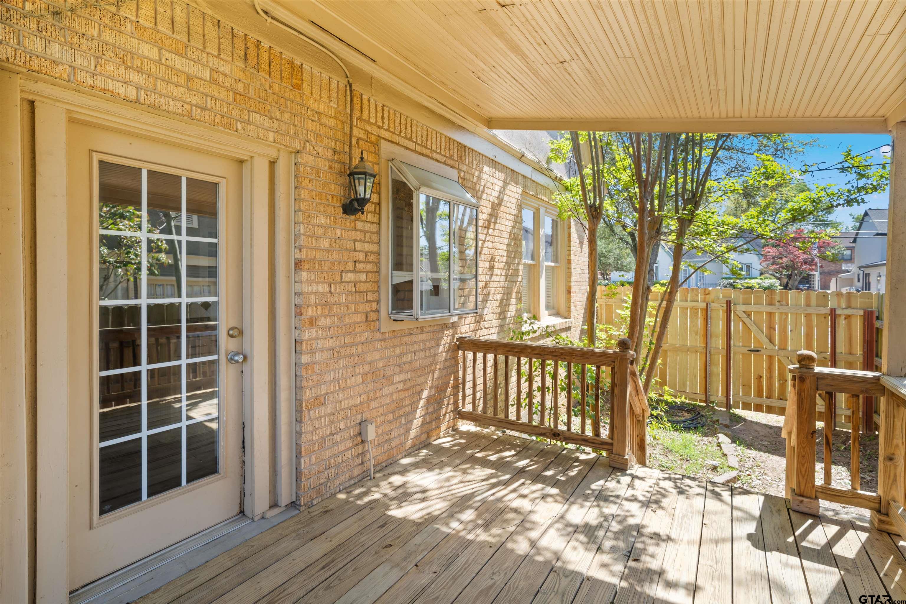 315 Mockingbird Lane Tyler, TX 75701 - Photo 15 of 33 a view of a porch with wooden floor and fence