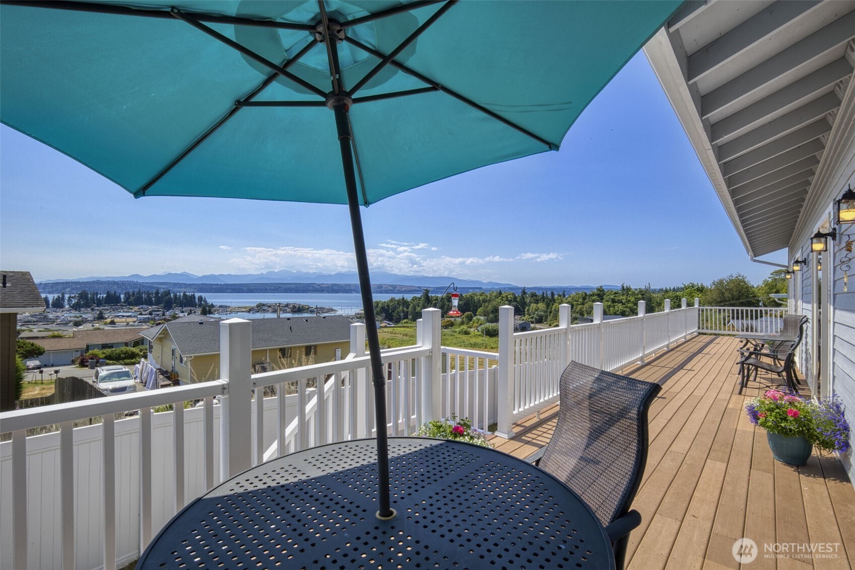 38292 Northeast Doe Road Hansville, WA 98340 - Photo 20 of 40 a view of a balcony with furniture and umbrella
