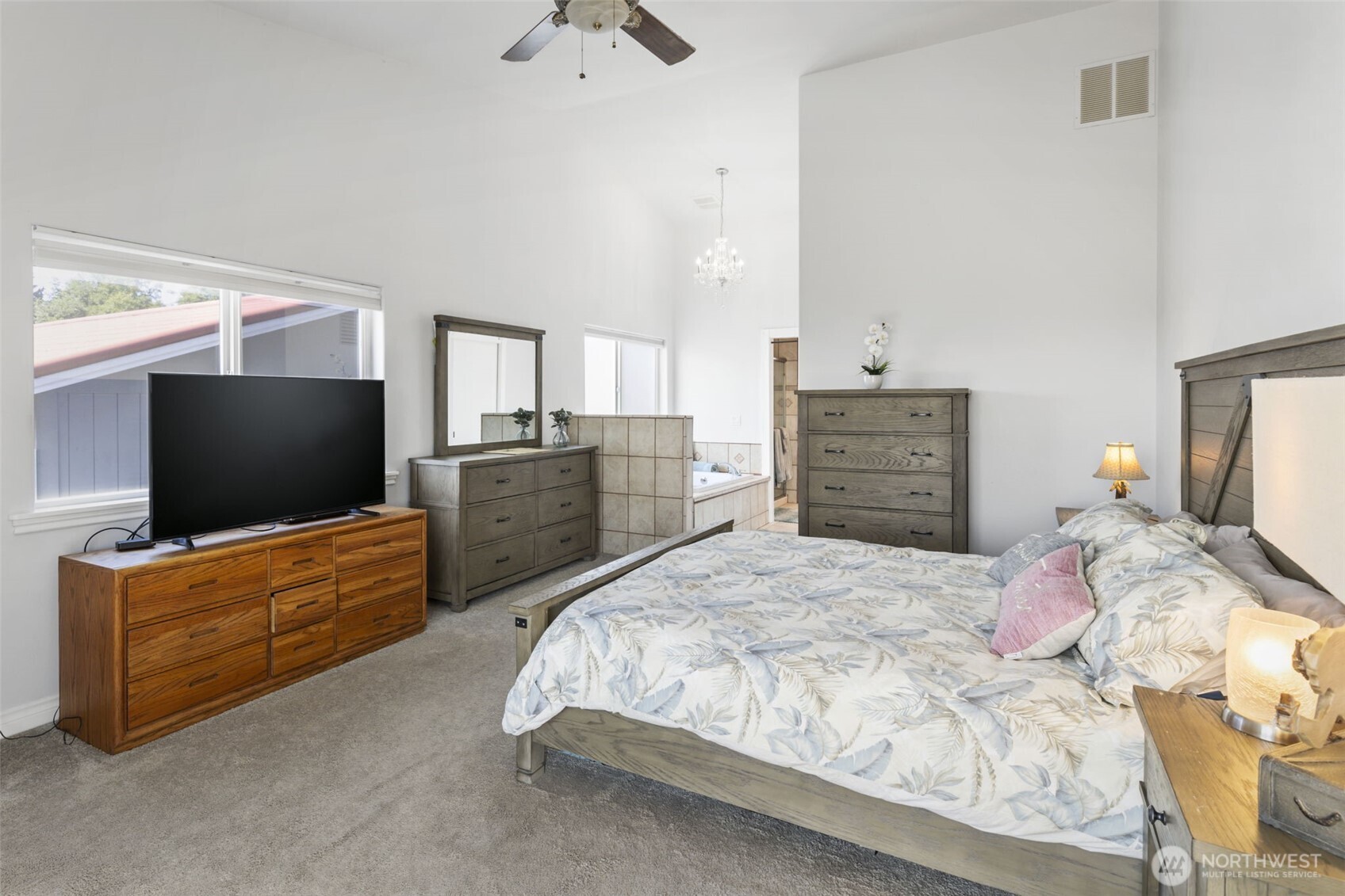38292 Northeast Doe Road Hansville, WA 98340 - Photo 25 of 40 a bedroom with a bed and flat screen tv