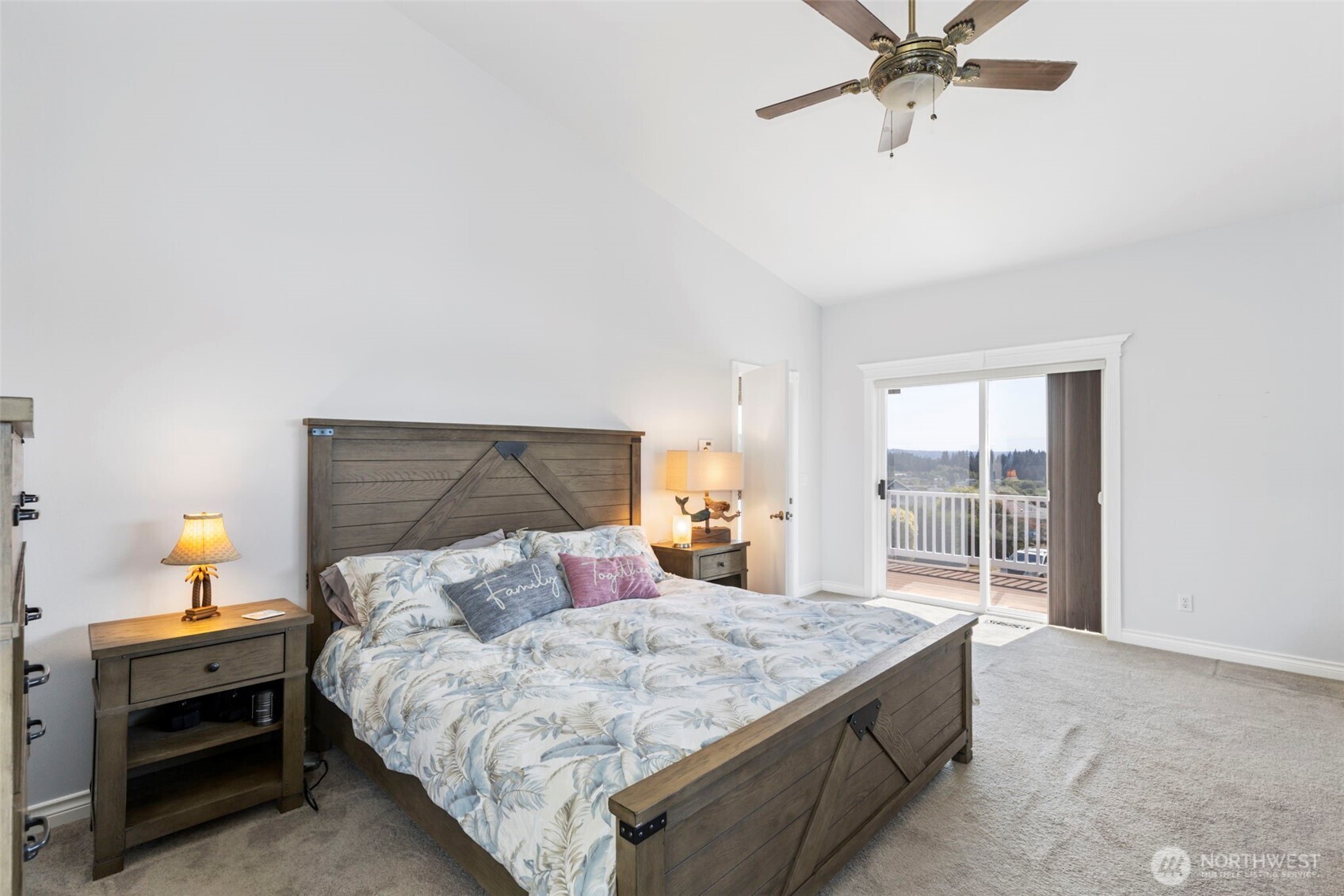 38292 Northeast Doe Road Hansville, WA 98340 - Photo 26 of 40 a bedroom with a large bed and a chandelier