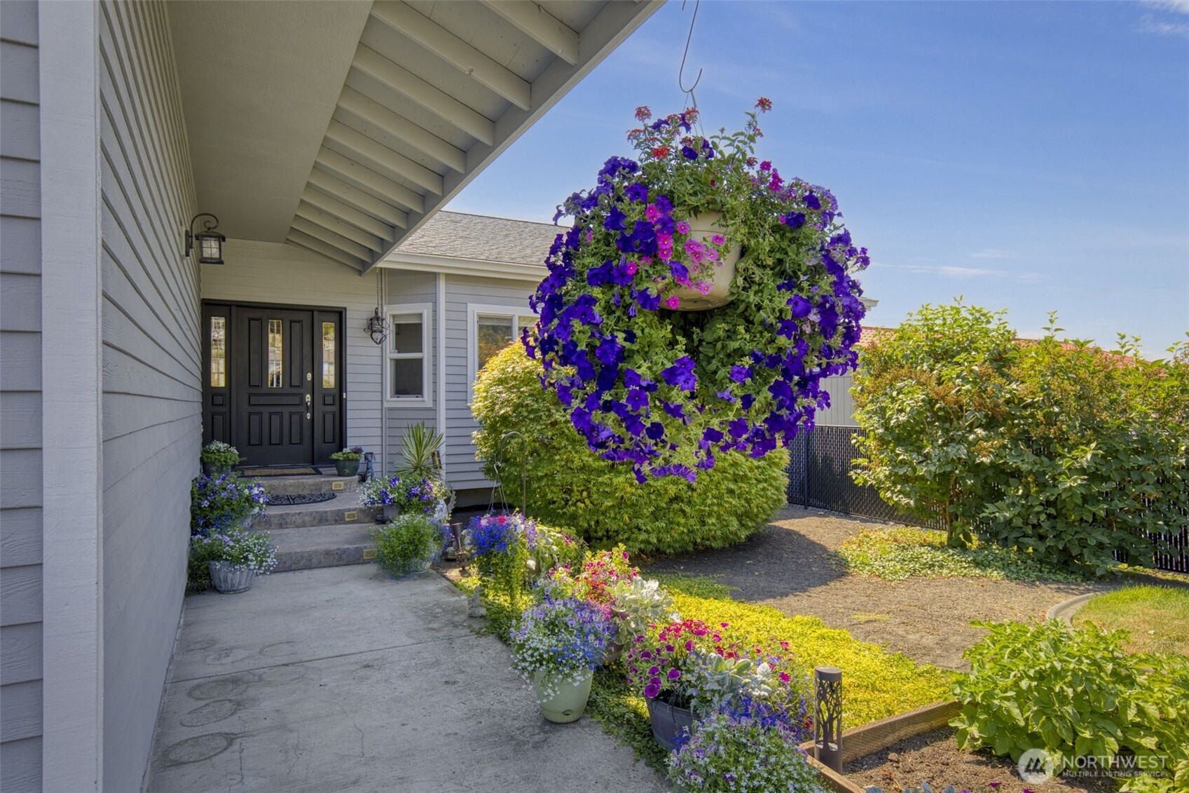 38292 Northeast Doe Road Hansville, WA 98340 - Photo 8 of 40 a bunch of flowers in front of the house