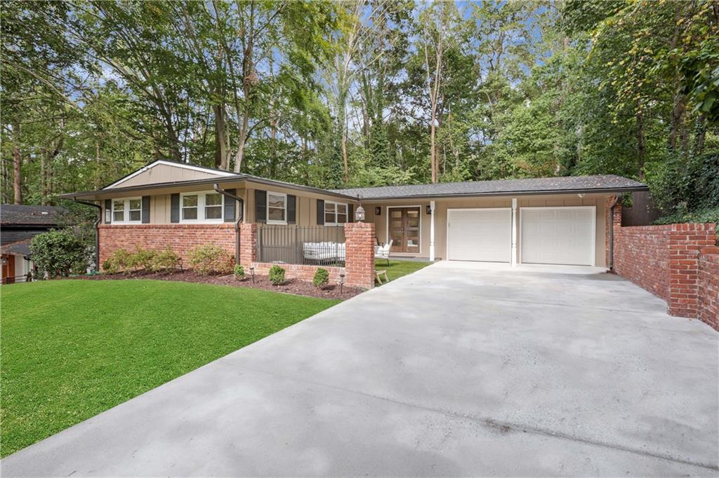 1572 Bubbling Creek Road Northeast Brookhaven, GA 30319 - Photo 1 of 1 a front view of a house with a yard and green space