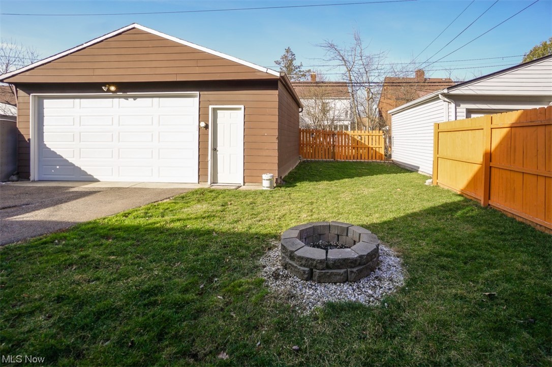 3631 Bainbridge Road Cleveland Heights, OH 44118 - Photo 20 of 20 View of backyard with a new garage, a fire pit and privacy fence.