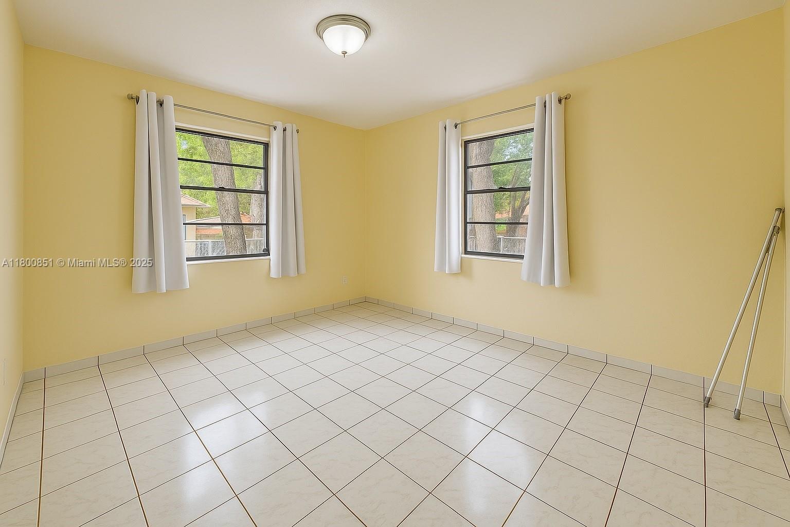 1741 Southwest 17th Court Miami, FL 33145 - Photo 6 of 13 an empty room with windows