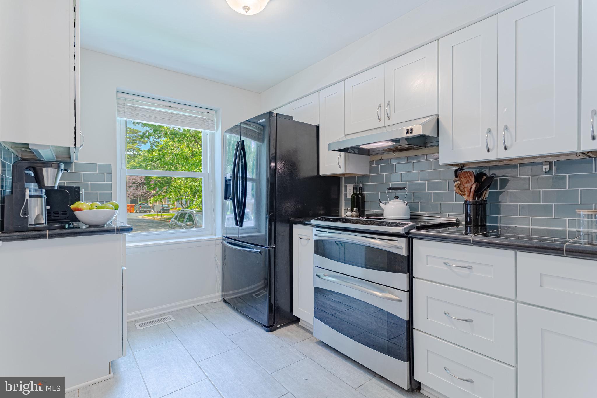 8325 Windfall Road Springfield, VA 22153 - Photo 12 of 34 Granite countertops and glass subway tiles