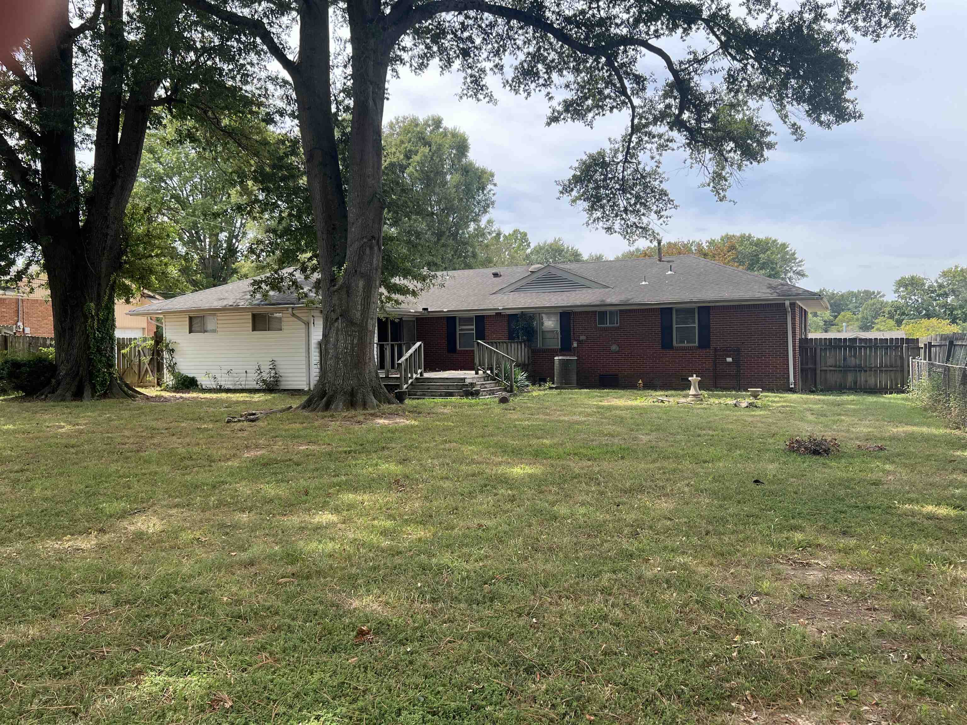 7202 Renda Street Millington, TN 38053 - Photo 4 of 18 a view of a white house with a yard and sitting area