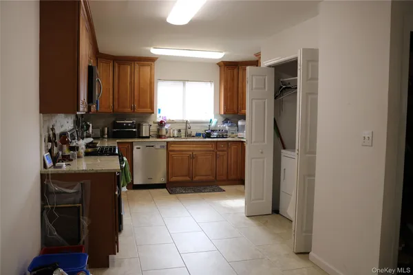 a kitchen with a sink a refrigerator and cabinets