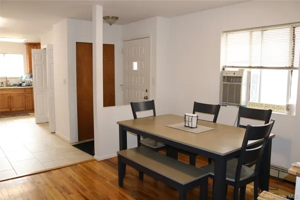 a view of a dining room with furniture and window