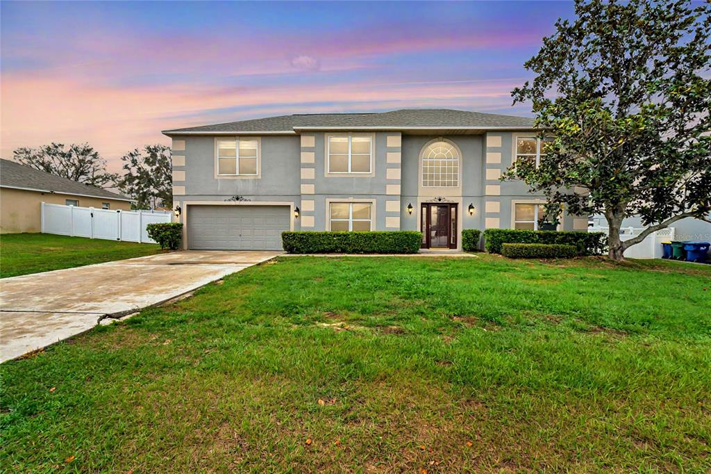 1787 Sunset Ridge Drive Mascotte, FL 34753 - Photo 1 of 1 a front view of house with yard and green space