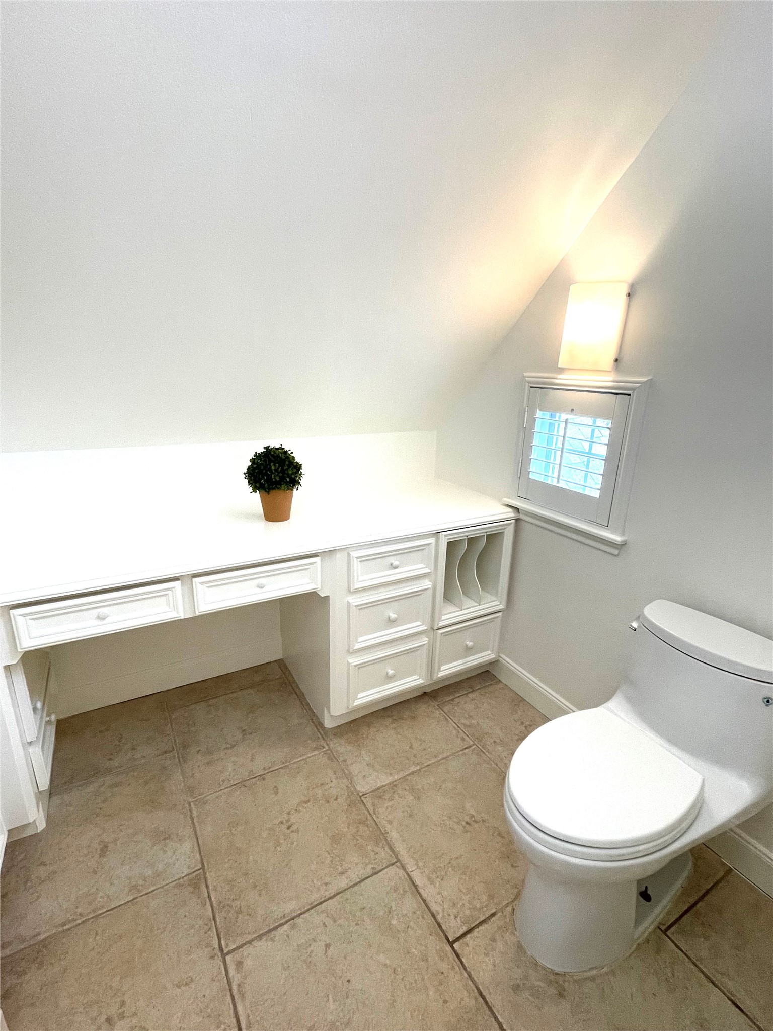 4334 Jefferson Street Houston, TX 77023 - Photo 17 of 31 a bathroom with a toilet a sink a window and mirror