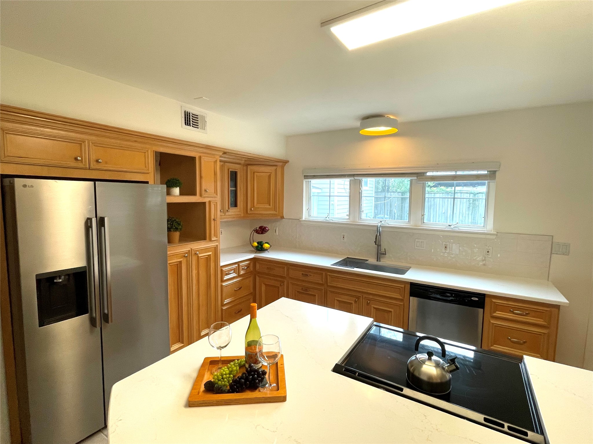 4334 Jefferson Street Houston, TX 77023 - Photo 3 of 31 a kitchen with stainless steel appliances granite countertop a sink and a refrigerator