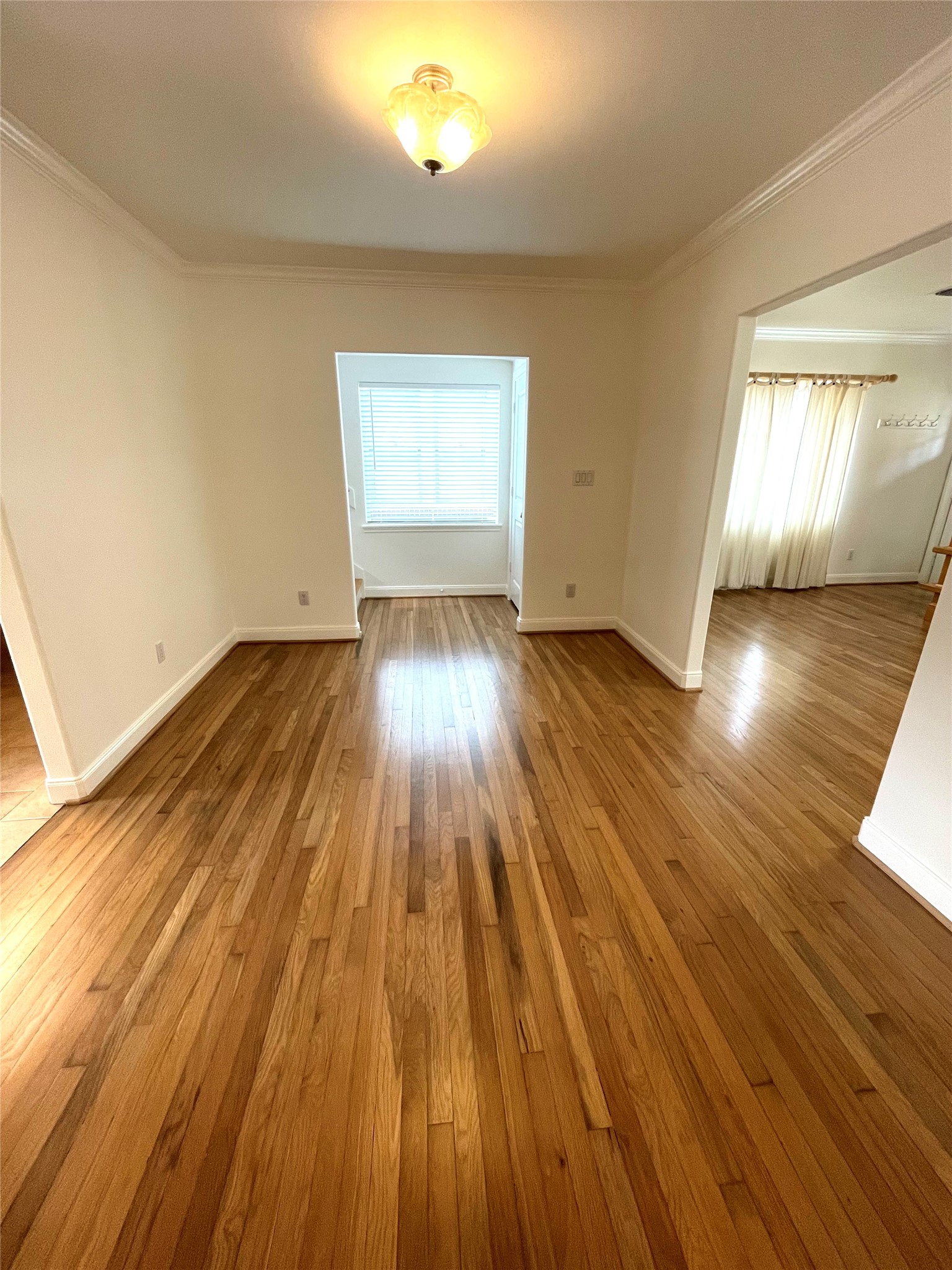 4334 Jefferson Street Houston, TX 77023 - Photo 6 of 31 an empty room with wooden floor and windows