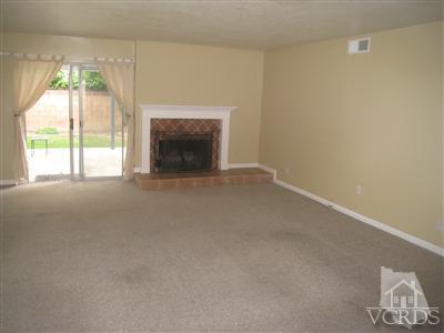 2958 Racine Street Simi Valley, CA 93065 - Photo 5 of 10 a view of an empty room with a fireplace and a window