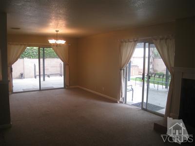 2958 Racine Street Simi Valley, CA 93065 - Photo 6 of 10 an empty room with a fireplace and large windows