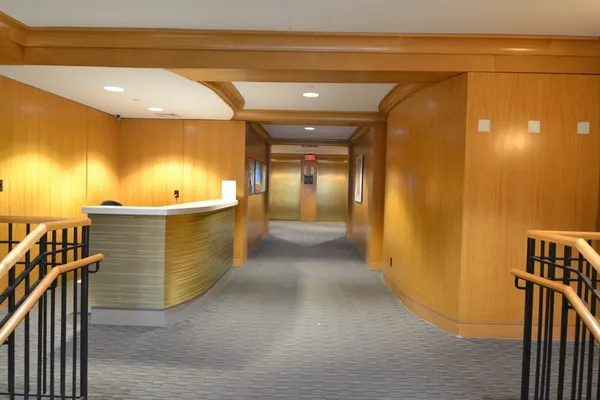 a view of a hallway with wooden shelves