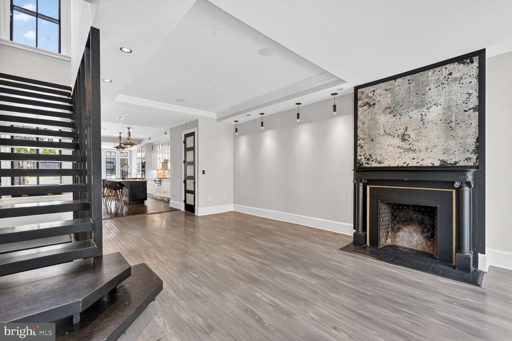 3019 Dent Place Northwest Washington, DC 20007 - Photo 2 of 17 a view of an empty room with wooden floor fire place and windows
