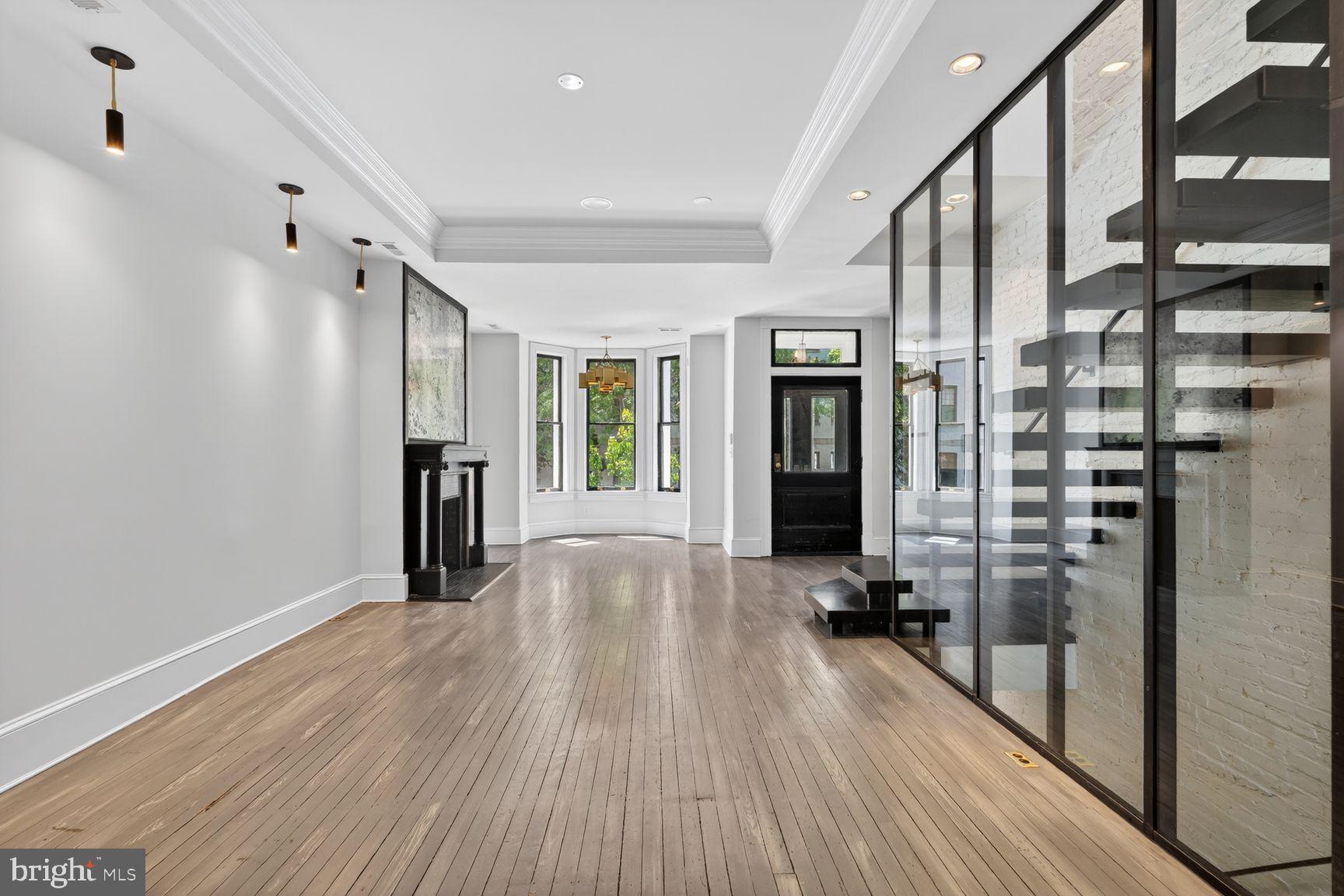 3019 Dent Place Northwest Washington, DC 20007 - Photo 3 of 17 a view of a hallway with wooden floor and windows