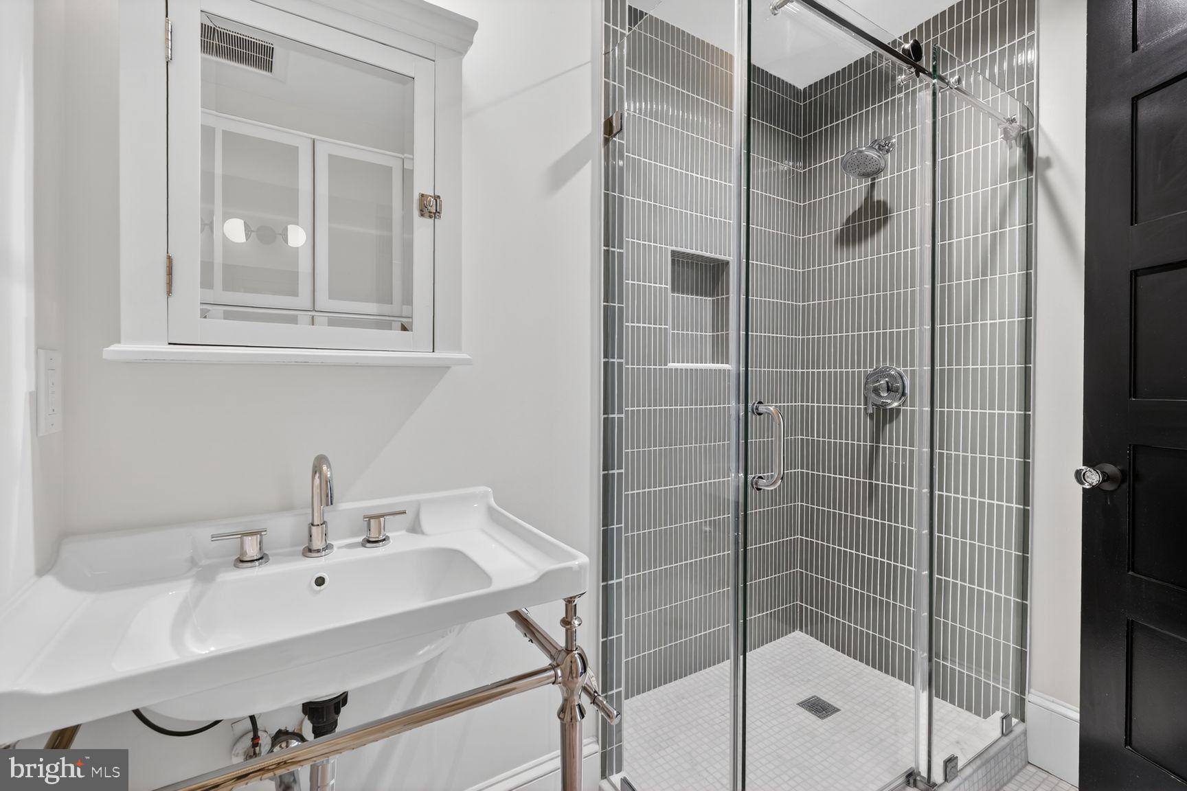 3019 Dent Place Northwest Washington, DC 20007 - Photo 9 of 17 a bathroom with a shower sink and mirror