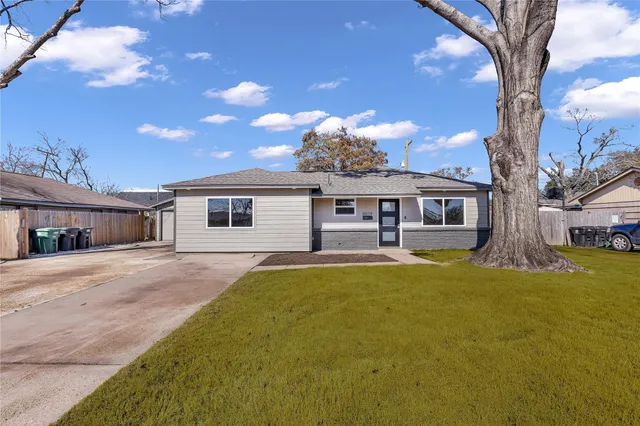 a front view of a house with yard porch and outdoor seating