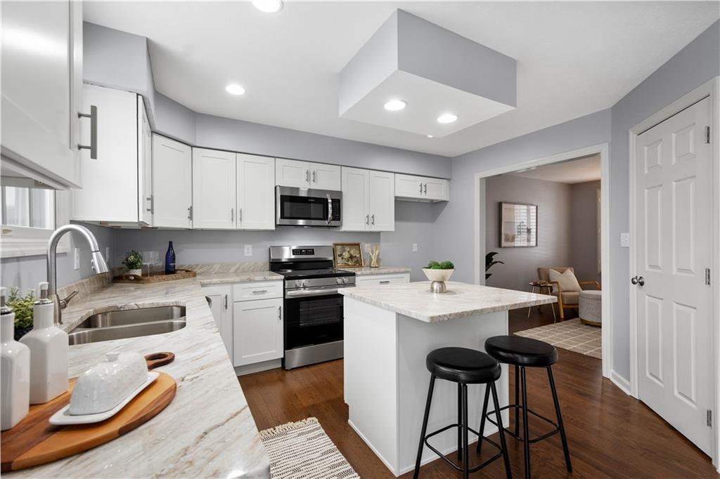 271 Overlook Court Coraopolis, PA 15108 - Photo 11 of 46 a open kitchen with stainless steel appliances granite countertop a stove top oven a sink a stove and white cabinets with wooden floor