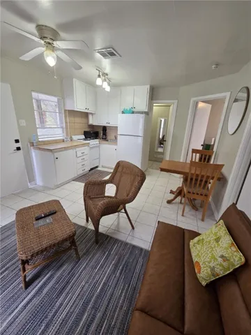 a living room with furniture and kitchen view