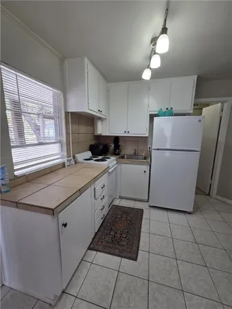 a kitchen with a cabinets a counter top space and a window