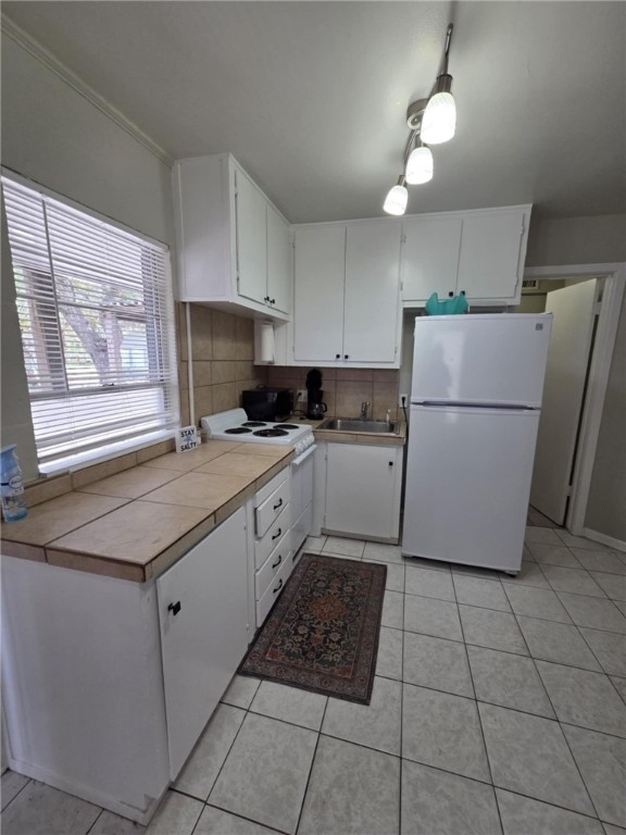 302 Broadway Street Fulton, TX 78382 - Photo 14 of 38 a kitchen with a cabinets a counter top space and a window