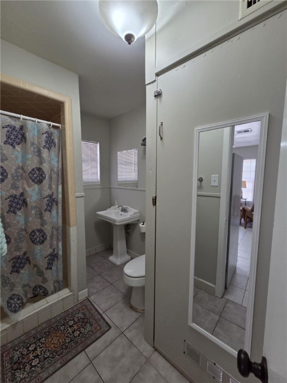 302 Broadway Street Fulton, TX 78382 - Photo 16 of 38 a bathroom with a toilet and a shower